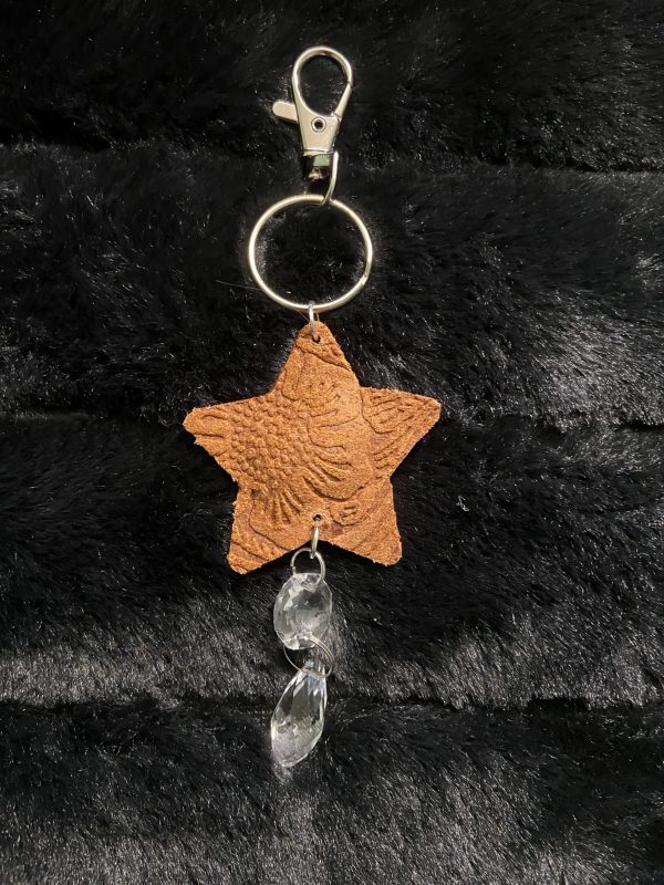 real leather embossed suncatcher key chain in caramel brown star